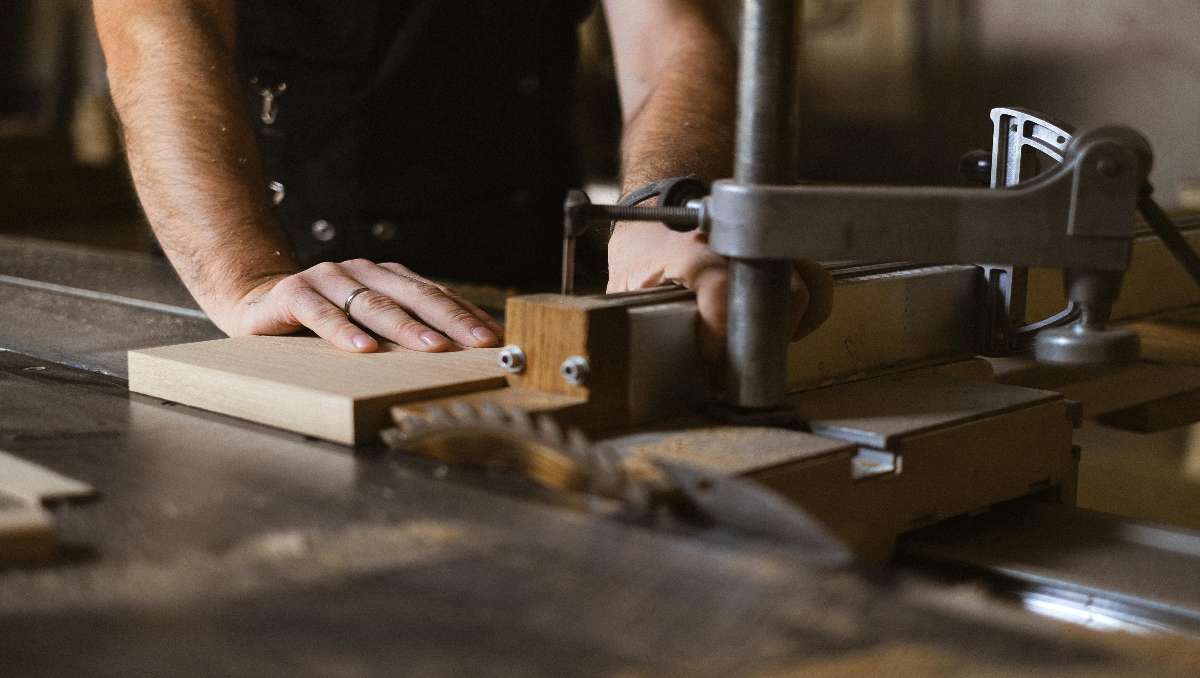 Crop craftsman working with furniture joints in workshop