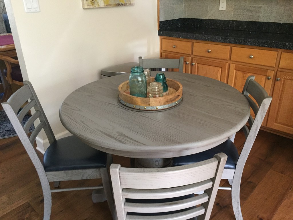 This round pedestal and Brady Dining Chairs are in Chelsea Gray glazed finish and the chairs are upholstered in Storm. But the table has a surprise: the Split Pedestal Dining Table extend from a single pedestal table to a triple pedestal capable of seating 18!—Amish Furniture Factory