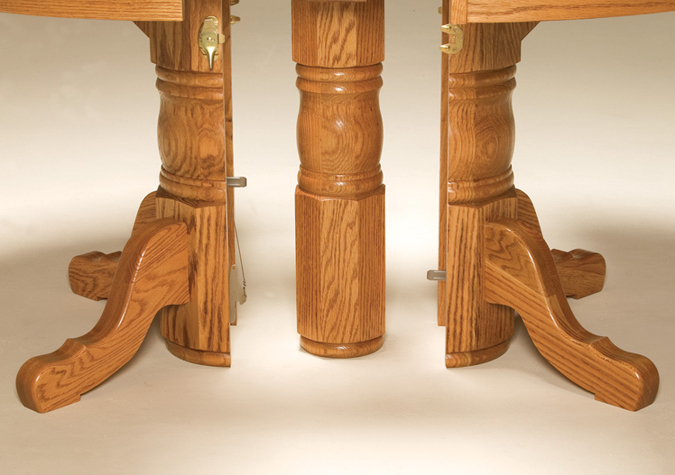 The Split Pedestal Dining Table looks like a single pedestal table, but it can open to create a triple pedestal table and seat up to 18!—Amish Furniture Factory