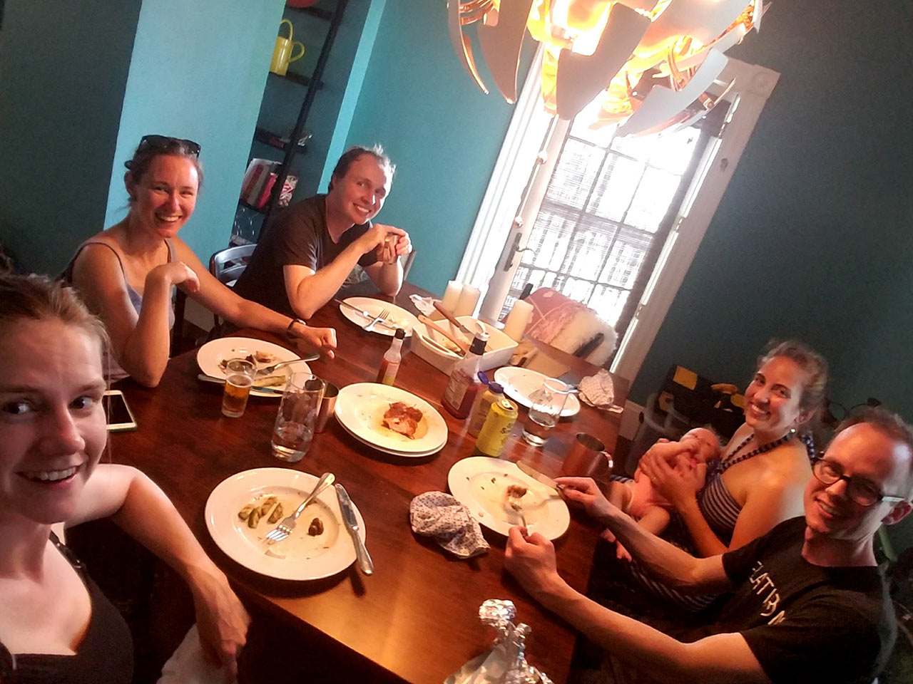 Several guests around a Laurie's Leg Dining Table from Amish Furniture Factory