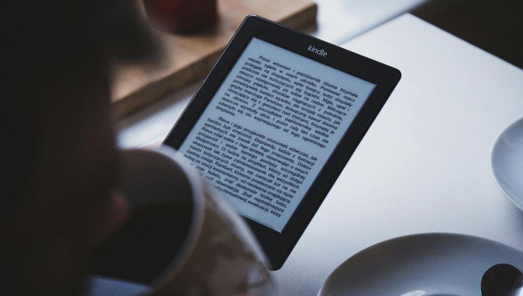 Woman reading book on Kindle