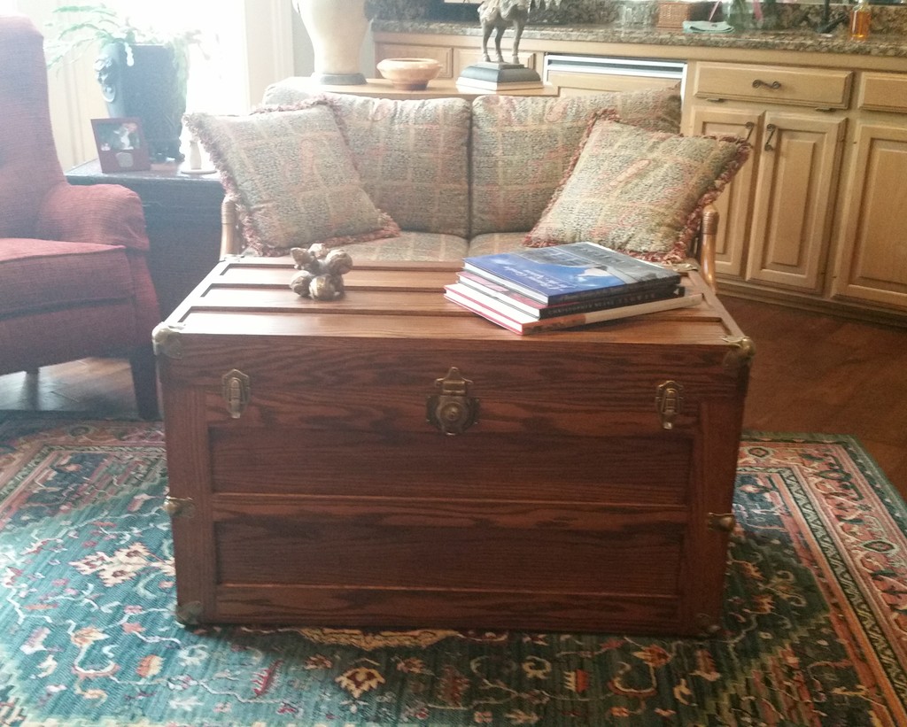 Amish Trunk with Flat Lid in oak with Acorn stain being used as a coffee table in the midst of living room upholstered living room seating—Amish Furniture Factory