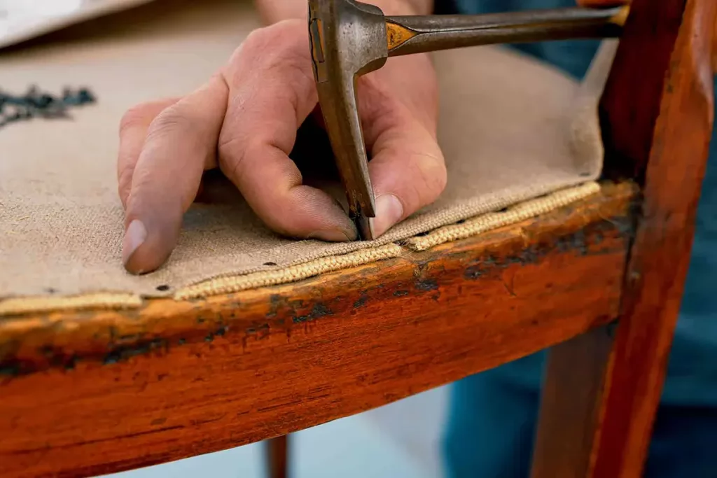 A hand restoring a wood furniture