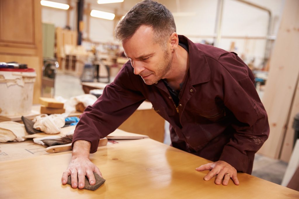 Man refinishing wood