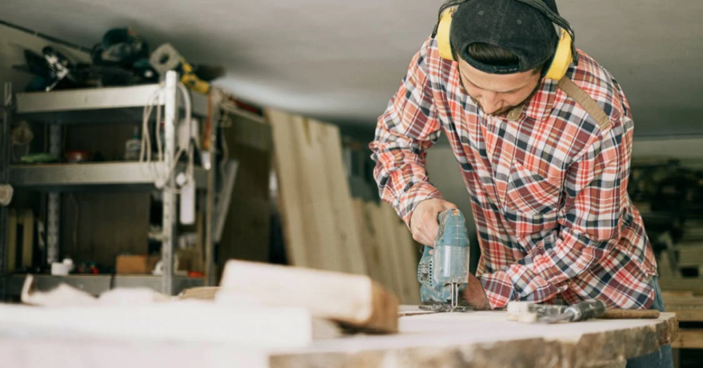 Man drilling the wood at his shop