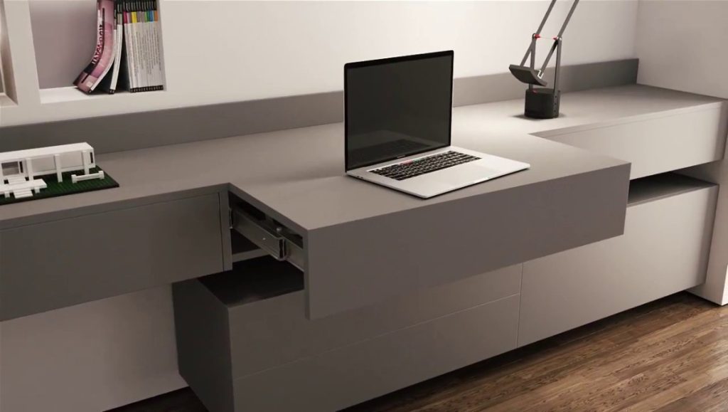 A pull out desk with laptop on top