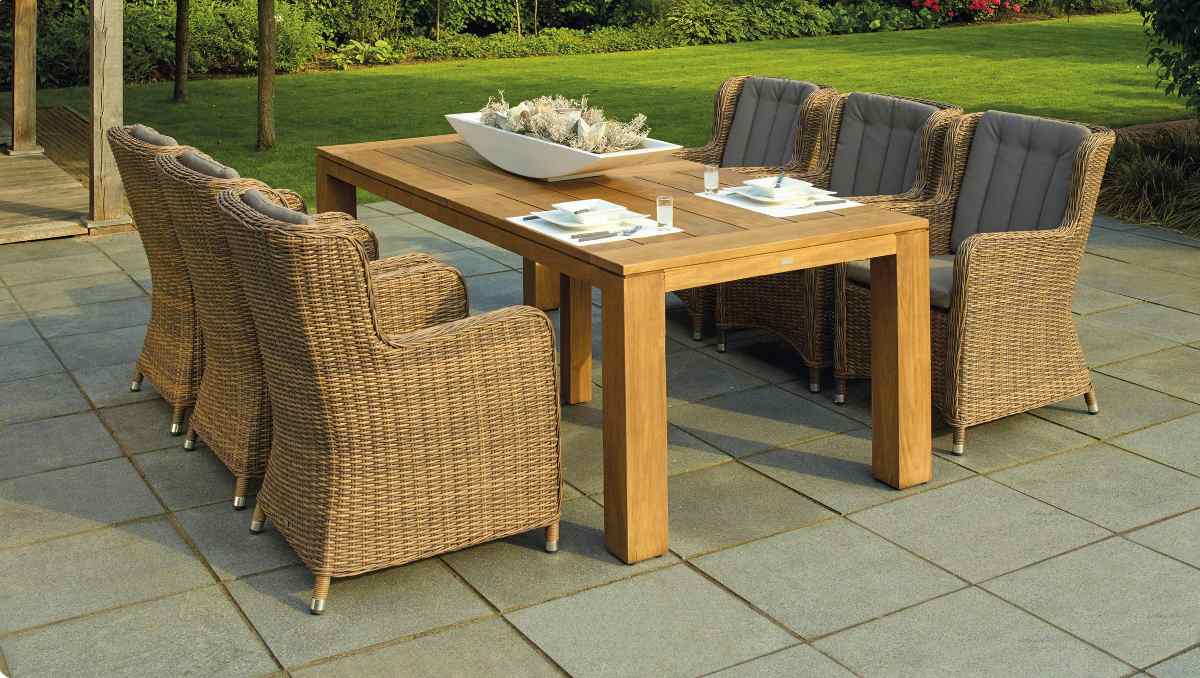 Wooden table and rattan chairs in outdoor furniture